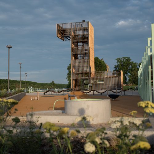 The playground of the promenade with the concrete sand-table. In the back there is the watch tower made of wood.
