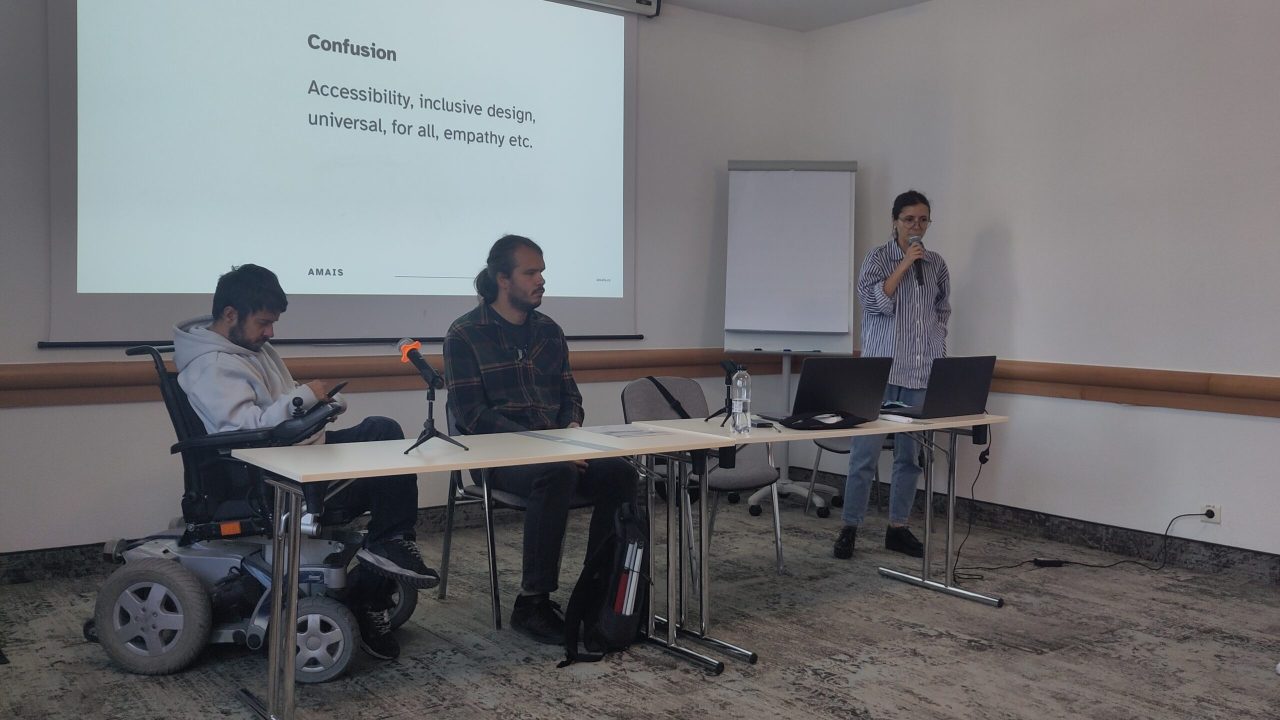 Iris, Alex and Alex presenting with images behind them on the wall.