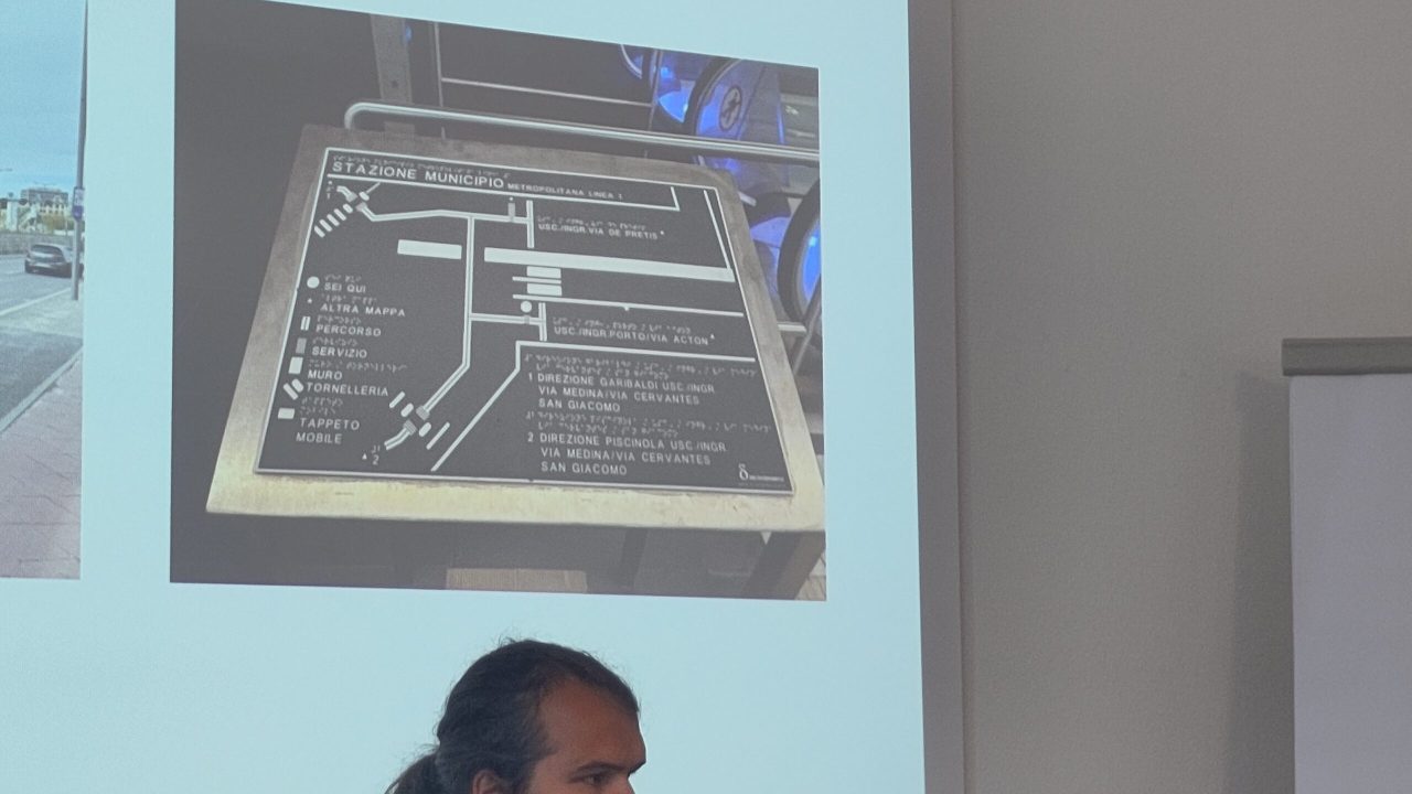 Close-up of Alex Cucu and a tactile map.